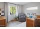 Cozy bedroom with a comfortable chair, soft rug, and a bookshelf filled with colorful books at 6114 N 8Th St, Phoenix, AZ 85014