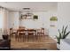 Bright dining area features hardwood floors, modern lighting, and stylish wood table with matching chairs at 6114 N 8Th St, Phoenix, AZ 85014