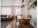 Bright dining area features hardwood floors, modern lighting, and stylish wood table with matching chairs at 6114 N 8Th St, Phoenix, AZ 85014