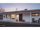 Inviting front porch with seating area, cacti in pots, and white brick facade at 6114 N 8Th St, Phoenix, AZ 85014