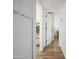 Bright hallway featuring wood floors and white doors, creating a clean and open feel throughout the home at 6114 N 8Th St, Phoenix, AZ 85014