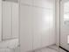 Hallway view of storage cabinets against a wall with tiled floors and a doorway at 6114 N 8Th St, Phoenix, AZ 85014