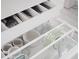 Open kitchen drawer with white organizers showing kitchen utensils and clear glass storage containers at 6114 N 8Th St, Phoenix, AZ 85014