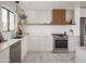 Contemporary kitchen with stainless steel appliances, light countertops, and a floating wood shelf at 6114 N 8Th St, Phoenix, AZ 85014