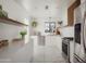 Bright, modern kitchen with white cabinets, marble floors, and stainless steel appliances at 6114 N 8Th St, Phoenix, AZ 85014