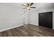 Neutral bedroom features wood floors, ceiling fan and black closet doors at 6207 N 10Th Way, Phoenix, AZ 85014