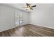 Neutral bedroom featuring wood floors, ceiling fan, plantation shutters and a brick accent wall at 6207 N 10Th Way, Phoenix, AZ 85014