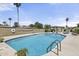 Sparkling community pool with clear blue water, lounge chairs and green landscaping at 6207 N 10Th Way, Phoenix, AZ 85014