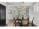 Cozy dining room with natural lighting, stylish wicker chairs, and a modern chandelier at 6207 N 10Th Way, Phoenix, AZ 85014