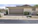 Two car garage with neutral facade and low maintenance front landscaping at 6207 N 10Th Way, Phoenix, AZ 85014