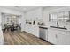 Bright modern kitchen with white countertops and cabinets, a stainless steel dishwasher, and wood floors at 6207 N 10Th Way, Phoenix, AZ 85014