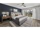 Beautiful main bedroom featuring a board and batten accent wall and sliding glass doors to the outdoor living space at 6207 N 10Th Way, Phoenix, AZ 85014