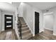 Staircase with carpet runner, modern black door, wood flooring and lots of light at 6207 N 10Th Way, Phoenix, AZ 85014