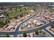 The aerial view shows a desert landscaped community on a golf course with native trees and lush fairways at 6450 S Windstream Pl, Chandler, AZ 85249