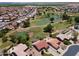 A high altitude aerial shot showcases a desert community on a golf course with ponds in the distance at 6450 S Windstream Pl, Chandler, AZ 85249