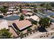 Aerial view of a desert landscaped home featuring a covered patio in a community with mature landscaping and desert terrain at 6450 S Windstream Pl, Chandler, AZ 85249
