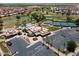 Aerial view of community clubhouse with pool, tennis courts, parking, and manicured landscaping at 6450 S Windstream Pl, Chandler, AZ 85249