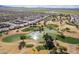 Scenic aerial view of community with a pond and golf course at 6450 S Windstream Pl, Chandler, AZ 85249