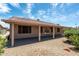 Relaxing covered patio area with landscaped yard with desert landscaping for easy maintenance and a serene atmosphere at 6450 S Windstream Pl, Chandler, AZ 85249
