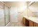 Bathroom featuring a shower with glass doors, and a spacious vanity with double sinks at 6450 S Windstream Pl, Chandler, AZ 85249