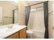Cozy bathroom featuring a combination tub and shower with gray curtains, with single sink vanity at 6450 S Windstream Pl, Chandler, AZ 85249