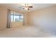 Bright bedroom featuring a large window with curtains and neutral carpet at 6450 S Windstream Pl, Chandler, AZ 85249