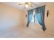 Bedroom featuring a ceiling fan and a window with blue curtains at 6450 S Windstream Pl, Chandler, AZ 85249