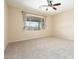 Spacious bedroom with carpet, ceiling fan and natural light coming through the sizable window at 6450 S Windstream Pl, Chandler, AZ 85249