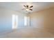 Spacious carpeted bedroom featuring a ceiling fan and white painted trim at 6450 S Windstream Pl, Chandler, AZ 85249