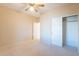 Spacious bedroom featuring a ceiling fan and a closet with sliding doors at 6450 S Windstream Pl, Chandler, AZ 85249