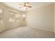 Bright and airy bedroom with carpeted floor and large windows at 6450 S Windstream Pl, Chandler, AZ 85249