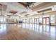 Expansive community center with hardwood floors, chandeliers and large windows letting in ample natural light at 6450 S Windstream Pl, Chandler, AZ 85249