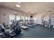 Spacious fitness center featuring a variety of cardio equipment with natural light from the windows at 6450 S Windstream Pl, Chandler, AZ 85249