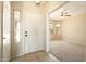 Inviting foyer featuring tile flooring and a view into a bright living space with a ceiling fan at 6450 S Windstream Pl, Chandler, AZ 85249