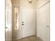 Entryway with tile flooring, a sidelight window, and access to a hallway with multiple doors at 6450 S Windstream Pl, Chandler, AZ 85249