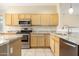 Updated kitchen featuring stainless steel appliances and granite countertops at 6450 S Windstream Pl, Chandler, AZ 85249
