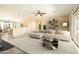 Open-concept living room featuring a large sectional, a modern coffee table, and seamless flow to the kitchen at 6450 S Windstream Pl, Chandler, AZ 85249