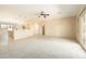 Open floor plan with carpeted living room connected to the bright kitchen area at 6450 S Windstream Pl, Chandler, AZ 85249