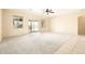 Spacious living room with carpet and natural light from the sliding glass doors at 6450 S Windstream Pl, Chandler, AZ 85249