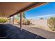 An open covered patio features views of the desert landscaping and blue sky in this backyard at 6450 S Windstream Pl, Chandler, AZ 85249