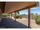 Covered patio with views of the landscaped backyard offers a relaxing outdoor space for dining and entertaining at 6450 S Windstream Pl, Chandler, AZ 85249