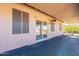 A covered patio has outdoor lighting and a sliding glass door to indoor living spaces at 6450 S Windstream Pl, Chandler, AZ 85249