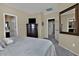 Serene bedroom with neutral decor, large dresser, and convenient access to the ensuite bathroom at 6614 W Victory N Way, Florence, AZ 85132