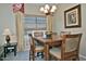 Dining room features a square wood table and 4 chairs, with bright window at 6614 W Victory N Way, Florence, AZ 85132