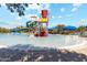 Community splash pad featuring colorful slides, fountains, and a giant tipping bucket, perfect for Gathering fun at 6614 W Victory N Way, Florence, AZ 85132