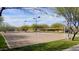 Outdoor sand volleyball court with yellow nets, surrounded by grass and desert landscaping at 6614 W Victory N Way, Florence, AZ 85132