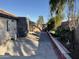 Spacious backyard showcasing landscaping, block fence, and an outdoor storage unit at 7551 W Pasadena Ave, Glendale, AZ 85303