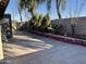 Stone paved backyard featuring desert landscaping with block fence and various trees at 7551 W Pasadena Ave, Glendale, AZ 85303