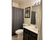 Cozy bathroom featuring shower, toilet, and vanity with mirror at 7551 W Pasadena Ave, Glendale, AZ 85303