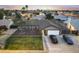 A scenic aerial view showcases the home's well-maintained yard, landscaping, and neighborhood at sunset at 8037 W Sweetwater Ave, Peoria, AZ 85381